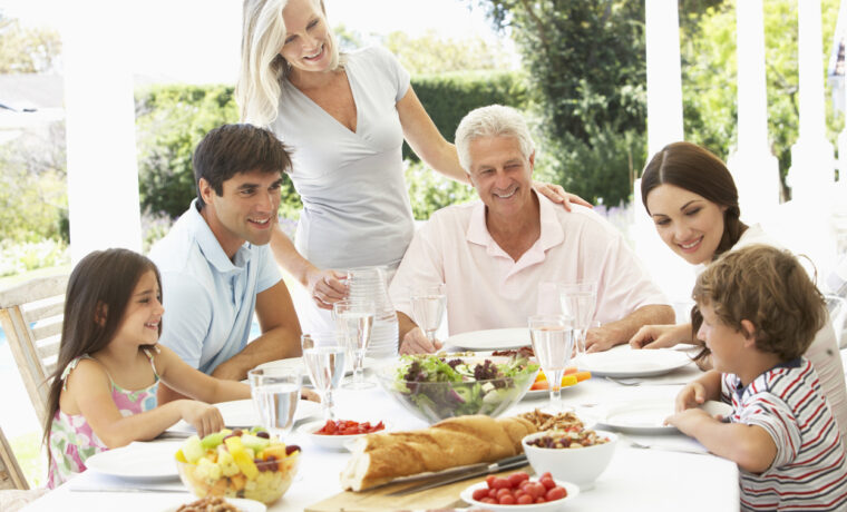 Three Generation Family Enjoying Meal Outdoors